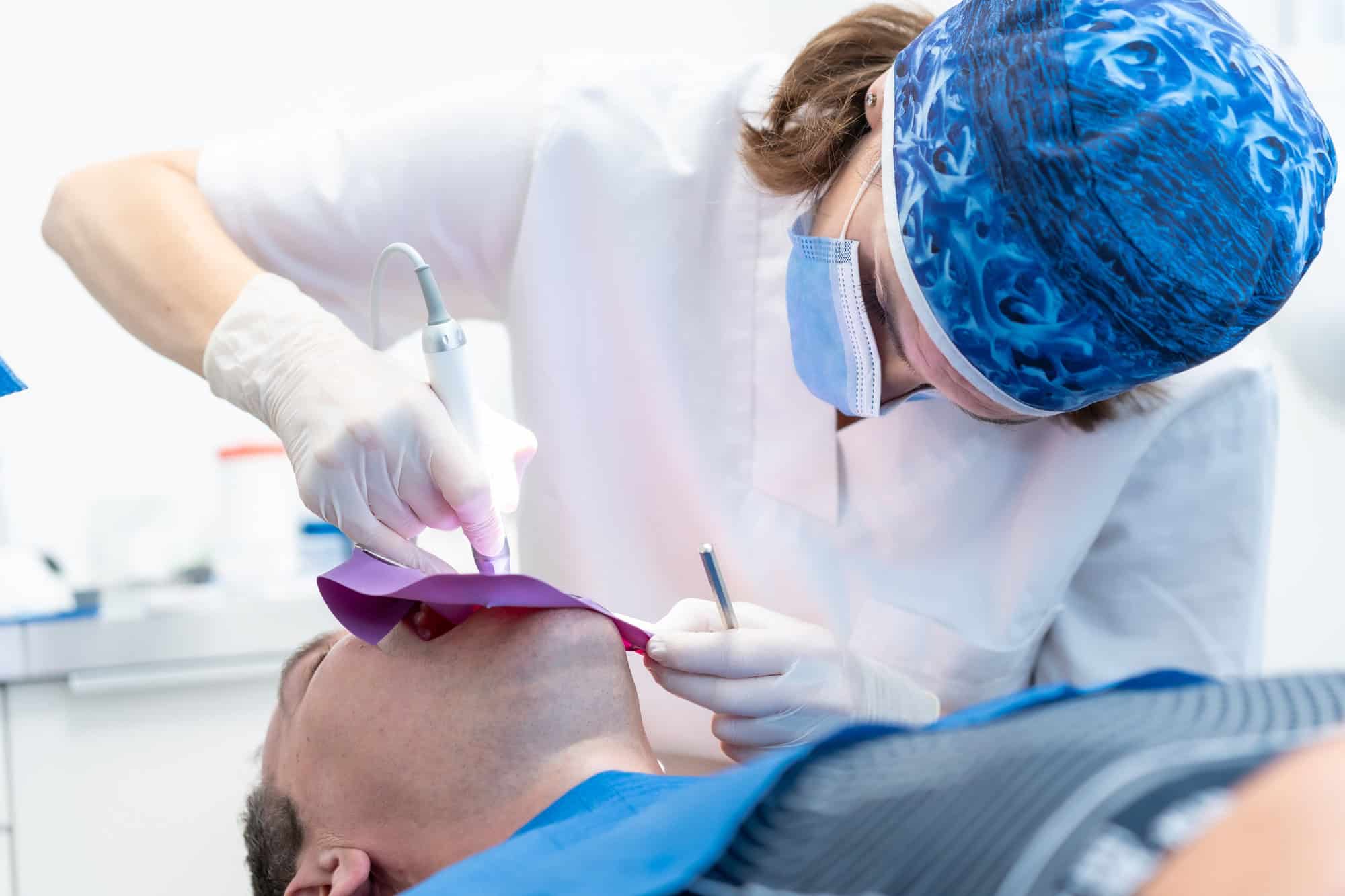 Dental clinic, a doctor performing a root canal to a patient in full operation