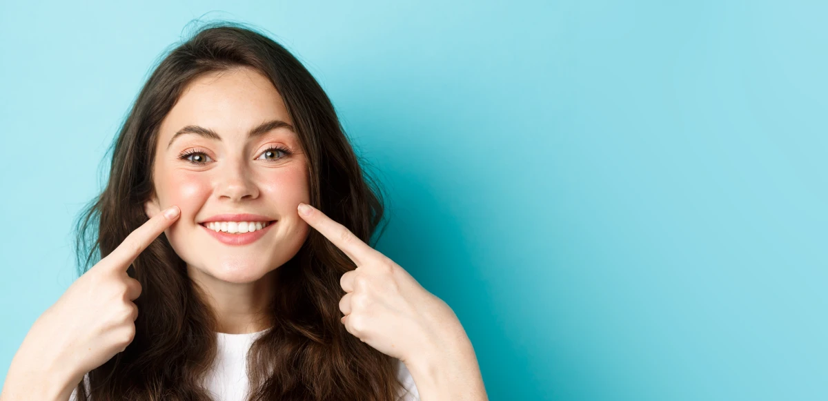 Confident patient with refreshed, youthful appearance after facial aesthetics treatment